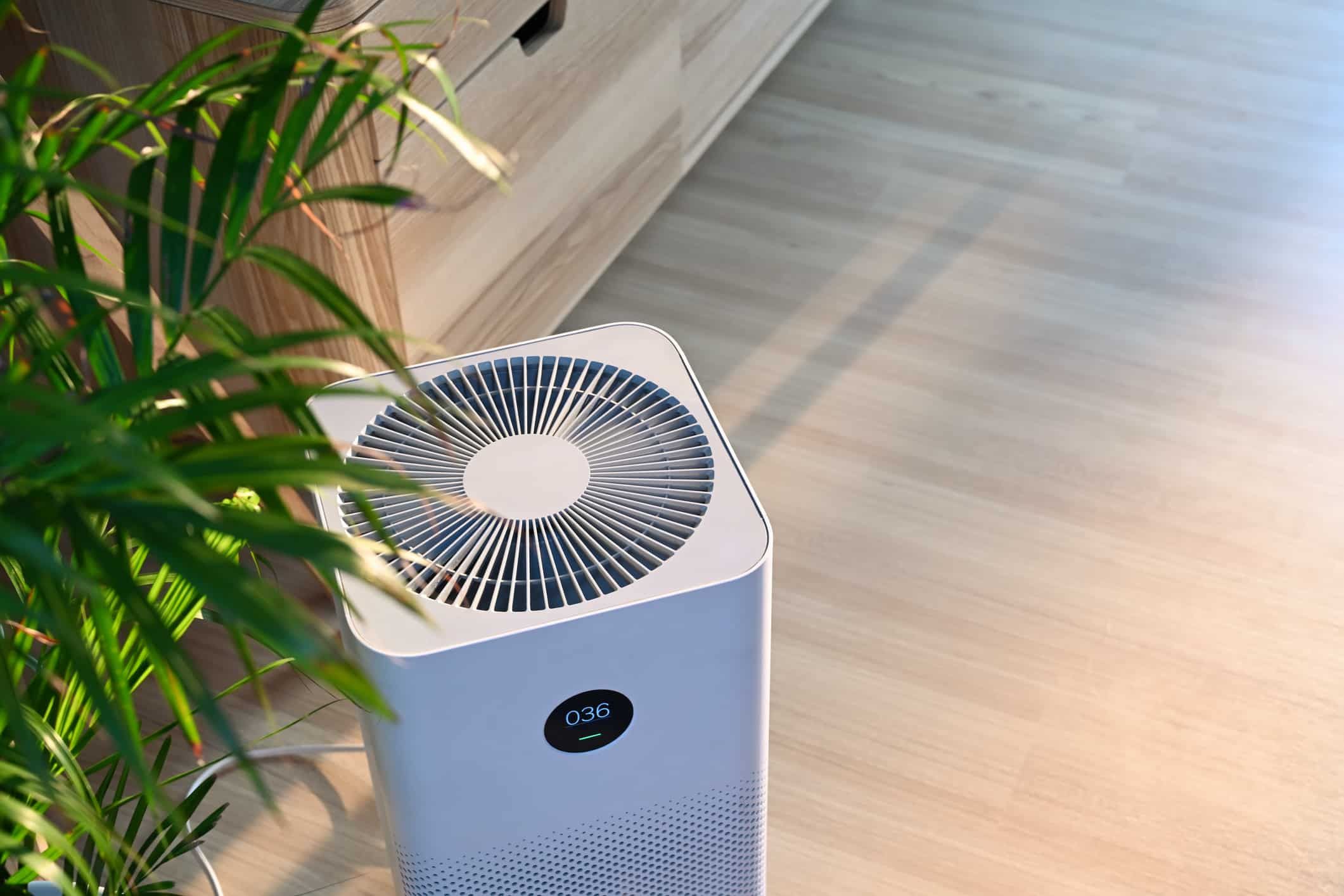 Air purifier on wooden floor in comfortable home. Air purifier on wooden floor in comfortable home.