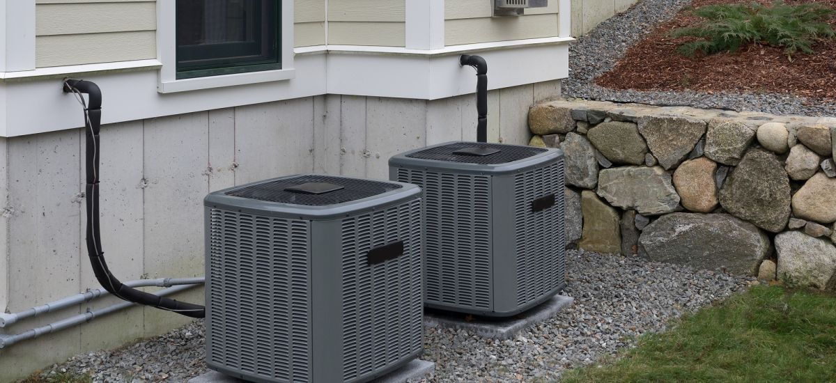 Heating and air conditioning units used to heat and cool a house sitting on a concrete slab next to a house in Mokena.