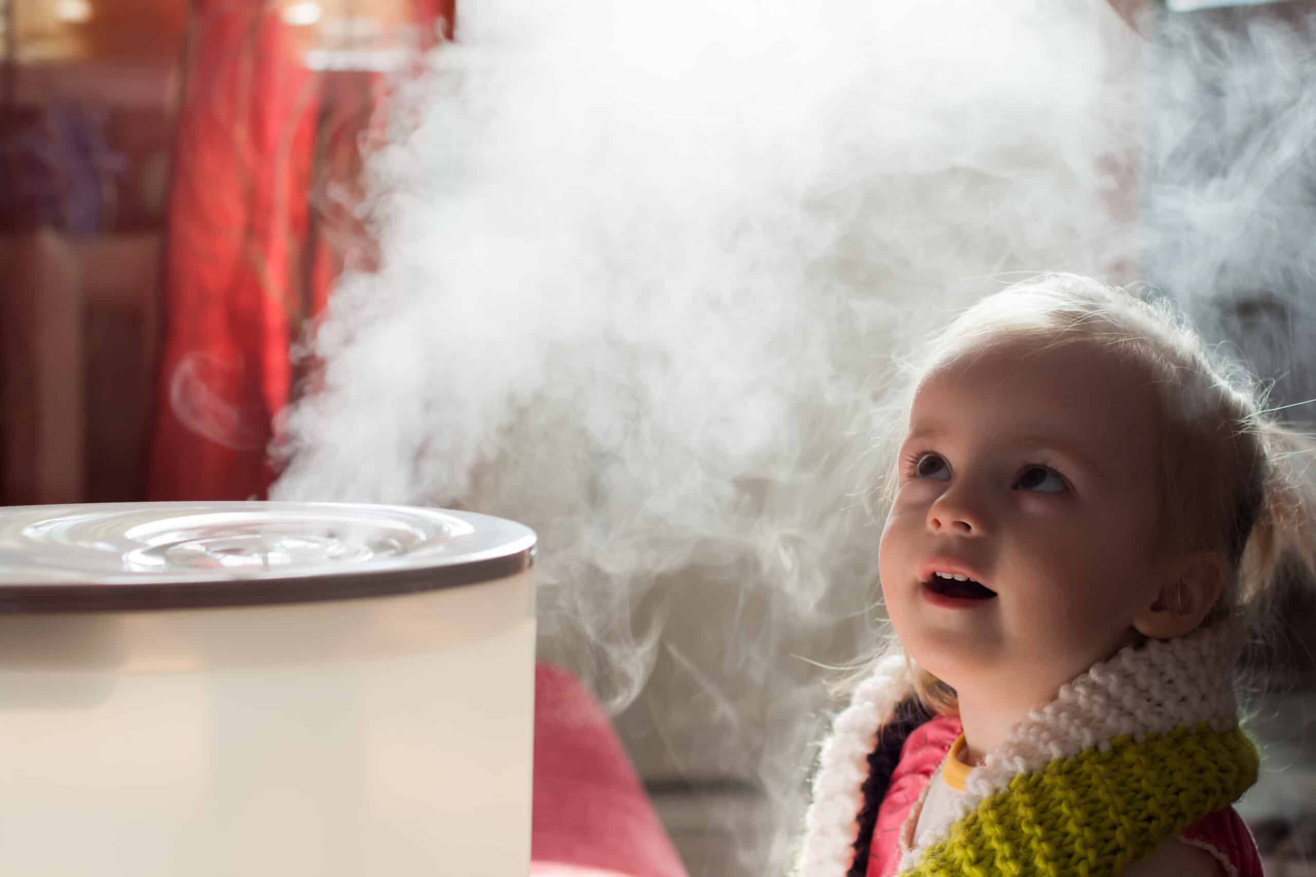 Child looking at home humidifier Child looking at home humidifier