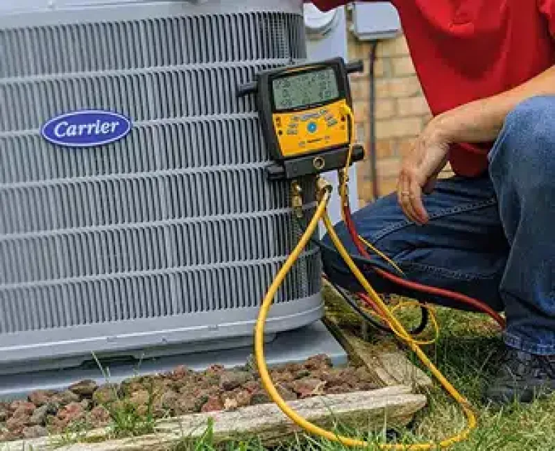 Tech performing a test on an outdoor unit