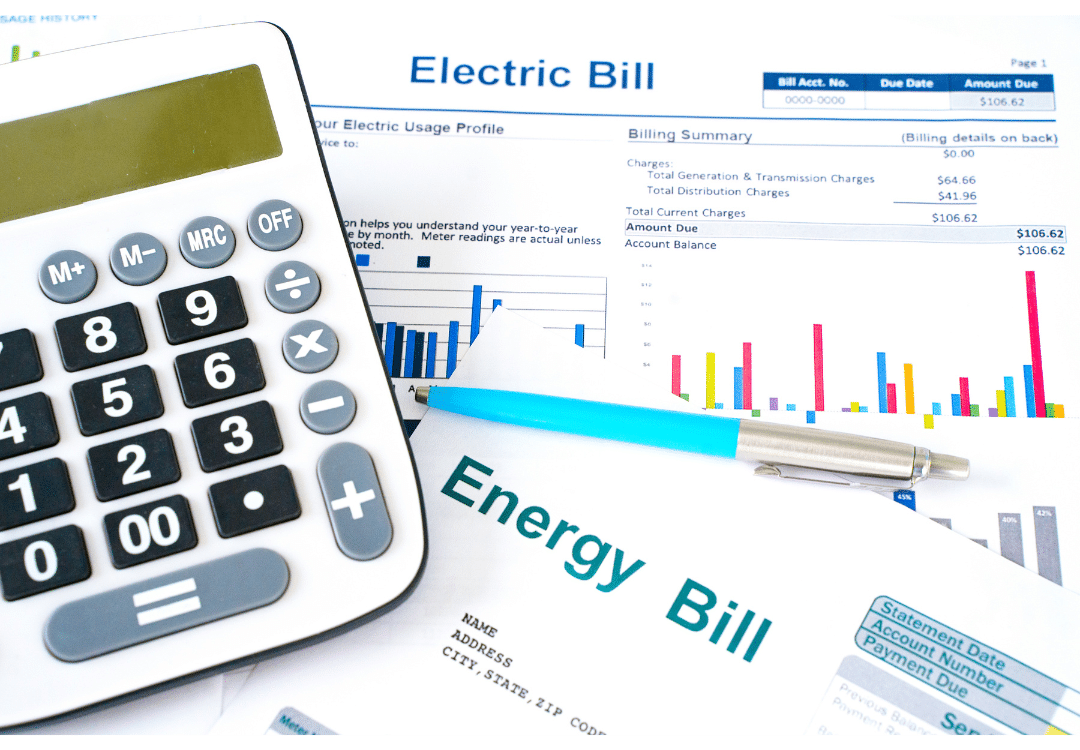 Calculator and pen on top of bills Calculator and pen on top of bills